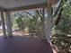 View from back porch through support columns overlooking woods and scenic foliage at 2706 Old Oak Walk, Seabrook Island, SC 29455