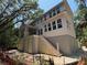 Exterior view of a two-story home with a covered porch, stairs, and light-colored siding at 2706 Old Oak Walk, Seabrook Island, SC 29455