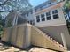 Exterior view of a two-story home with a covered porch, stairs, and light-colored siding at 2706 Old Oak Walk, Seabrook Island, SC 29455