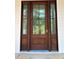 An elegant stained wood front door with glass panels and white trim creates a welcoming entrance at 2706 Old Oak Walk, Seabrook Island, SC 29455