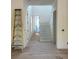 Hallway with stairs and natural light from multiple windows with new paint at 2706 Old Oak Walk, Seabrook Island, SC 29455