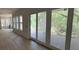 Bright living room with large windows and sliding glass doors leading to outdoor deck at 2706 Old Oak Walk, Seabrook Island, SC 29455