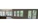 Bright living room with large windows and sliding glass doors providing outdoor scenery at 2706 Old Oak Walk, Seabrook Island, SC 29455