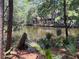 Scenic view of a home overlooking a tranquil pond surrounded by lush greenery and trees at 2706 Old Oak Walk, Seabrook Island, SC 29455