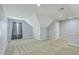 Spacious bonus room with neutral carpet, gray walls, a window with curtains, and a door leading to another area at 271 Village Stone Cir, Summerville, SC 29486