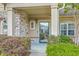 Home featuring a welcoming front porch with meticulously maintained landscaping at 271 Village Stone Cir, Summerville, SC 29486