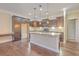 Spacious kitchen showcases a center island with granite countertops, dark wood cabinets, and wood floors at 271 Village Stone Cir, Summerville, SC 29486