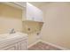 Functional laundry room with a utility sink, white cabinets, and plenty of space for appliances at 271 Village Stone Cir, Summerville, SC 29486