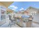 Outdoor kitchen area features a built-in grill and bar, perfect for entertaining guests and summer cookouts at 271 Village Stone Cir, Summerville, SC 29486