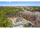 A picturesque aerial view of the home nestled within the lush green forest, river in background at 2725 Starfish Dr, Johns Island, SC 29455