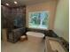 Elegant bathroom featuring a soaking tub, tiled shower, and serene forest views at 2725 Starfish Dr, Johns Island, SC 29455