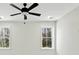 This bedroom offers two windows and an updated ceiling fan with light fixture at 2725 Starfish Dr, Johns Island, SC 29455
