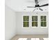 This bedroom has an updated ceiling fan with light fixture and three windows at 2725 Starfish Dr, Johns Island, SC 29455