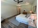 Bright bedroom features a fan, light colored wood flooring, and a comfortable bed at 2725 Starfish Dr, Johns Island, SC 29455