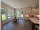 Bright dining area featuring a wooden table, many windows, and an open concept kitchen at 2725 Starfish Dr, Johns Island, SC 29455