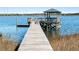 A wooden dock with a gazebo extends into the water, offering tranquil waterfront views at 2725 Starfish Dr, Johns Island, SC 29455