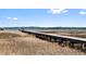 A long wooden dock stretches across a marsh towards the peaceful waterfront, promising serene views at 2725 Starfish Dr, Johns Island, SC 29455