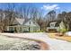 Stunning exterior of a two-story home featuring a spacious driveway and detached garage in a wooded setting at 2725 Starfish Dr, Johns Island, SC 29455