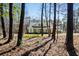 Charming home exterior featuring a gabled roof and a welcoming front porch surrounded by mature trees at 2725 Starfish Dr, Johns Island, SC 29455