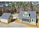 An exterior shot highlighting home, garage, lush landscaping, a charming screened porch, and ample natural light at 2725 Starfish Dr, Johns Island, SC 29455