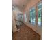 Bright foyer with brick floors, showcasing the entrance, staircase, and view of the front yard through the front door at 2725 Starfish Dr, Johns Island, SC 29455