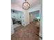 Elegant foyer with brick floors, contemporary lighting, and views into the office and living spaces at 2725 Starfish Dr, Johns Island, SC 29455