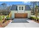 Charming garage with wood door and a finished upper level offers ample parking and additional living space at 2725 Starfish Dr, Johns Island, SC 29455
