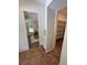Hallway view into dining room, brick floor, and storage nook with white cabinets at 2725 Starfish Dr, Johns Island, SC 29455