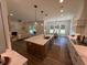 Open-concept kitchen with an island, stainless appliances, and marble countertops at 2725 Starfish Dr, Johns Island, SC 29455
