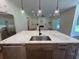 Kitchen island featuring stainless steel appliances, a sink, and marble countertops at 2725 Starfish Dr, Johns Island, SC 29455