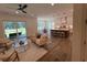 Open-concept living room showcasing hardwood floors, a comfortable sofa, and bright natural light at 2725 Starfish Dr, Johns Island, SC 29455