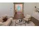 Cozy living room with stylish furnishings, a round glass coffee table, and an inviting view into the foyer at 2725 Starfish Dr, Johns Island, SC 29455