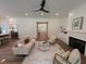 Bright and airy living room with modern decor, a fireplace, and an open view towards the kitchen and foyer at 2725 Starfish Dr, Johns Island, SC 29455