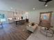 Open-concept living room, kitchen and dining area with a large island and hardwood flooring throughout at 2725 Starfish Dr, Johns Island, SC 29455