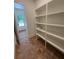Walk-in pantry features bright white shelving, tile floors, and view to the front entryway at 2725 Starfish Dr, Johns Island, SC 29455