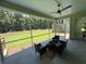 Cozy screened porch with chairs and a table, overlooking the backyard and wooded area at 2725 Starfish Dr, Johns Island, SC 29455