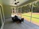 Screened porch with seating overlooking a lush yard and wooded area at 2725 Starfish Dr, Johns Island, SC 29455