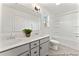 Bathroom with double sink vanity, white cabinets, and shower-tub at 279 Surf Bird Rd # 465, Summerville, SC 29486