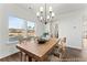 Bright dining area featuring a wooden table, modern lighting, and large windows at 279 Surf Bird Rd # 465, Summerville, SC 29486