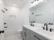 Modern bathroom featuring double vanity, sleek fixtures, and a shower-tub with white subway tile at 2924 Chicora Ave, North Charleston, SC 29405