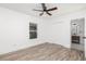 Bedroom with wood-look flooring, a ceiling fan, closet and adjacent bath for convenience at 2924 Chicora Ave, North Charleston, SC 29405