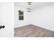 Bright bedroom with wood floors, white walls, and a window offering natural light at 2924 Chicora Ave, North Charleston, SC 29405
