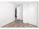 Bright bedroom with wood floors, white walls, and closet space at 2924 Chicora Ave, North Charleston, SC 29405