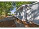 Charming exterior showcasing the light blue siding, and convenient parking on a paved driveway at 2924 Chicora Ave, North Charleston, SC 29405