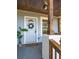 Close-up of a welcoming front door with wood columns, a wreath, and a patterned doormat at 2924 Chicora Ave, North Charleston, SC 29405