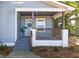 Inviting front porch with a gray floor, wood pillars, brick base, and a stylish wreath at 2924 Chicora Ave, North Charleston, SC 29405