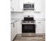 Close-up of a modern kitchen with stainless steel appliances, marble countertops, and white cabinets at 2924 Chicora Ave, North Charleston, SC 29405