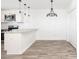 Eat-in kitchen featuring a breakfast bar, modern lighting, and stainless steel appliances at 2924 Chicora Ave, North Charleston, SC 29405