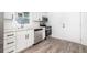 Bright kitchen with white cabinets, subway tile backsplash, stainless steel appliances, and wood floors at 2924 Chicora Ave, North Charleston, SC 29405