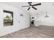 Bright living room with hardwood floors, fan, and views into the modern white kitchen at 2924 Chicora Ave, North Charleston, SC 29405